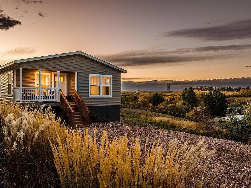 Manufactured home with a front porch on rural property